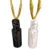 abstract angelic sculptures – black & white seated duo with golden wings