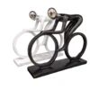 abstract cyclist sculptures – dynamic black & white duo with artistic flow
