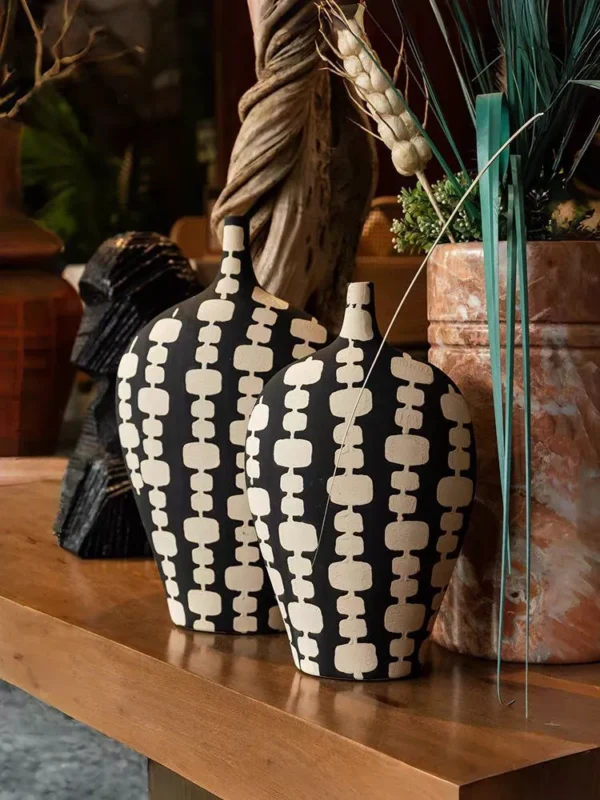 black ceramic vase duo with cream artistic motifs black ceramic vase duo with cream artistic motifs