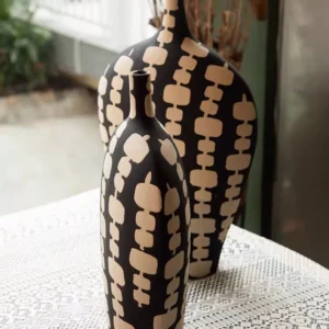 black ceramic vase duo with cream artistic motifs
