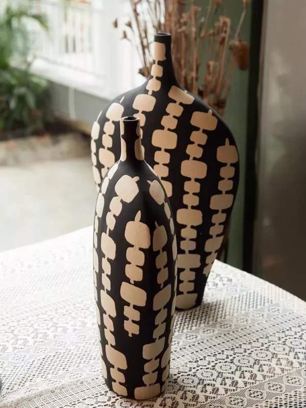black ceramic vase duo with cream artistic motifs black ceramic vase duo with cream artistic motifs