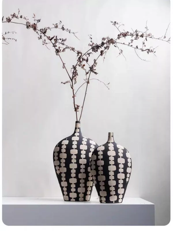 black ceramic vase duo with cream artistic motifs black ceramic vase duo with cream artistic motifs