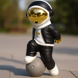 casual astronaut sculpture – black & white design with gold helmet on planet base