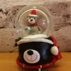 christmas snow globe decoration – bear with gift on playful bear face base