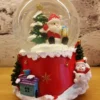 christmas snow globe decoration – santa with gift and tree on festive red base