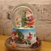 christmas snow globe – santa & snowman scene with gift sleigh and toy train base