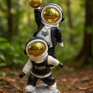 dual astronaut sculpture – playful black & white design with gold accents