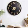 black wall clock with gold accents and industrial charm