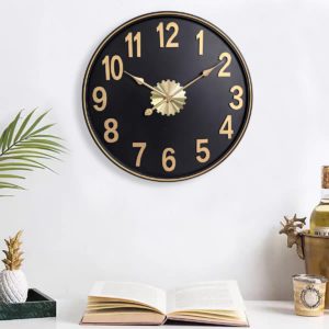 black wall clock with gold accents and industrial charm