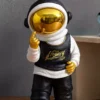 urban astronaut sculpture – black & white design with gold accents